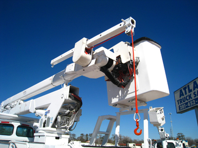 Hydraulic binch material handler next to bucket.
