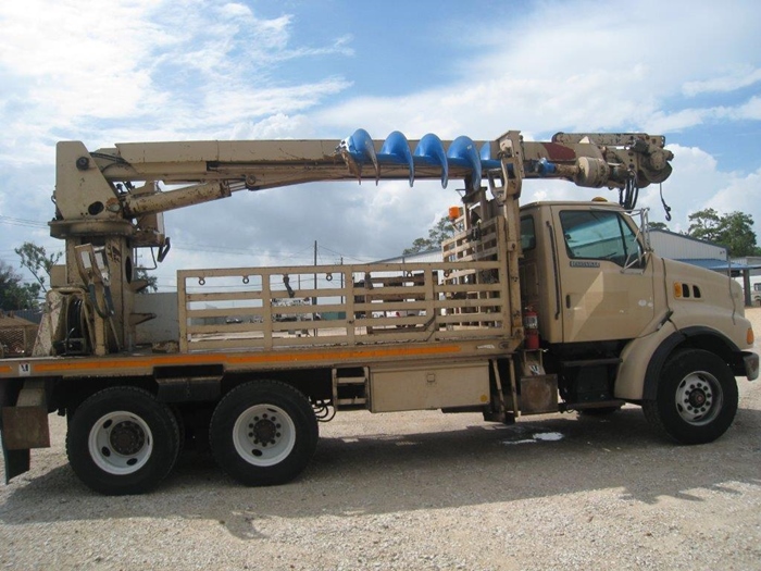 Digger truck with auger.