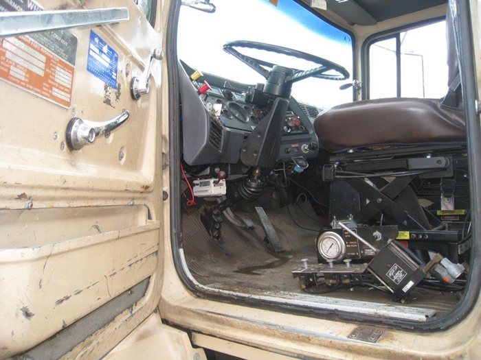 Stand up controls digger truck.