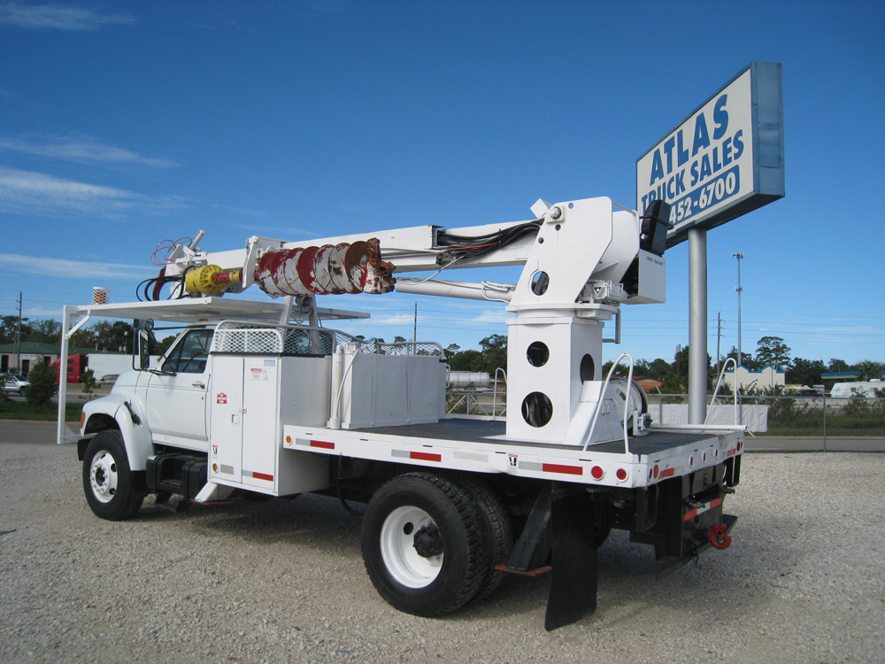 Flat bed digger derrick truck.