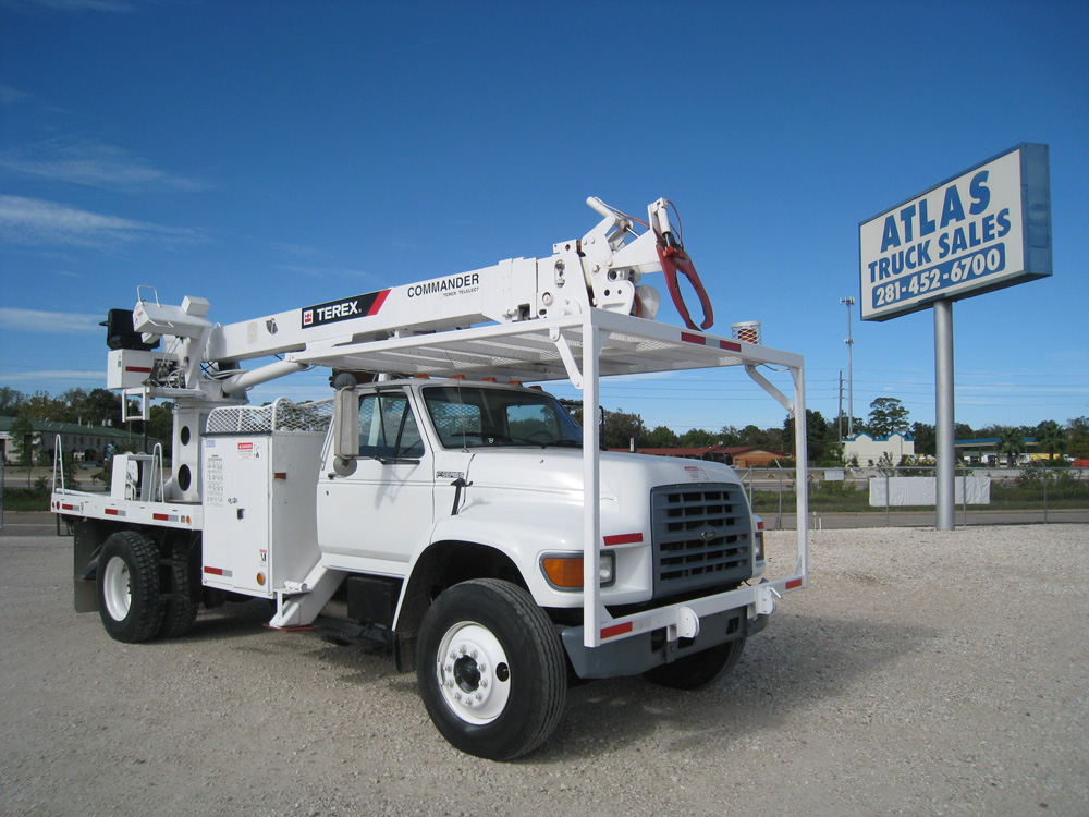 Digger trucks with hydraulic hose reels.